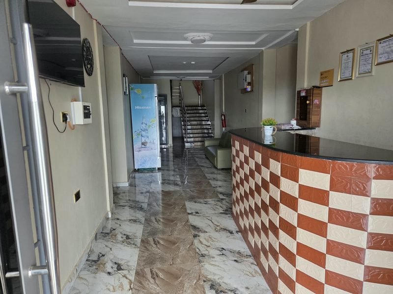 The reception desk in the lobby, with its marbled floor and tiled counter